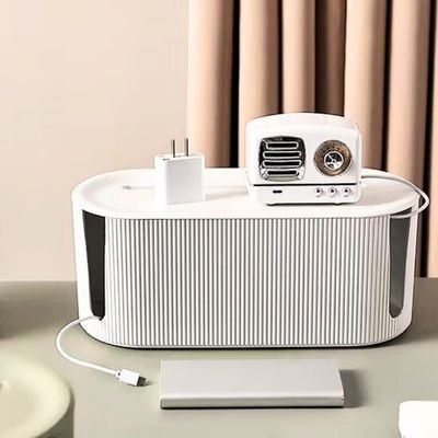 boite range cable fils sortant côte articles Bluetooth dessus