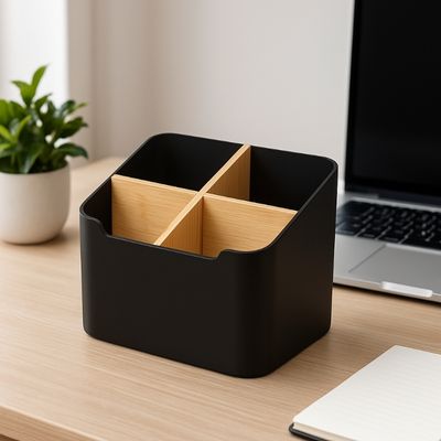 organiseur de bureau noir sur bureau ordinateur portable plante